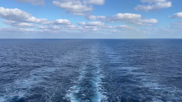 Cruise ship wake or trail on ocean surface. a wide footprint from the boat.