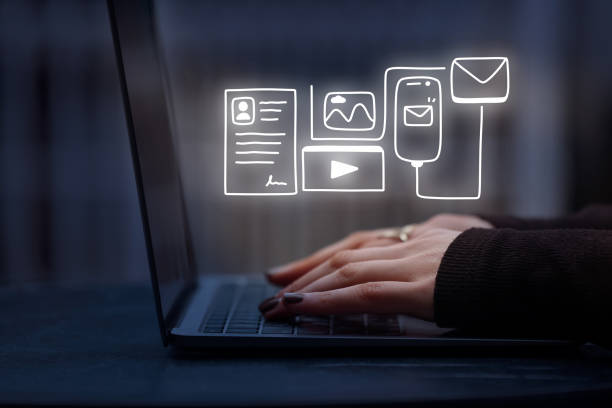 istock Woman using laptop with digital content icons 1474398646