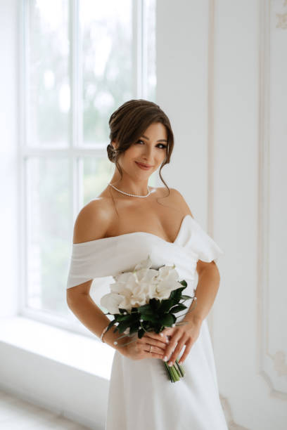 istock brunette bride in a tight wedding dress in a bright studio 1474398785