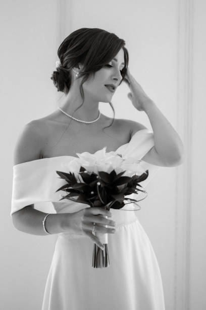 istock brunette bride in a tight wedding dress in a bright studio 1474399152