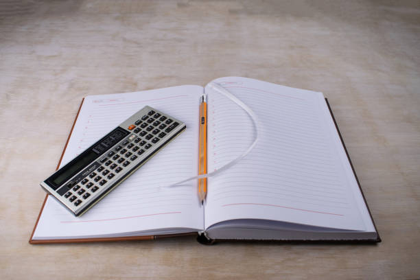 Retro vintage pocket computer data bank on a notebook pencil bookmarker stock photo