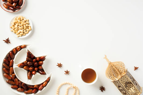istock Ramadan Kareem Islamic greeting card with lantern, dried dates, nuts, cup of tea 1474400108