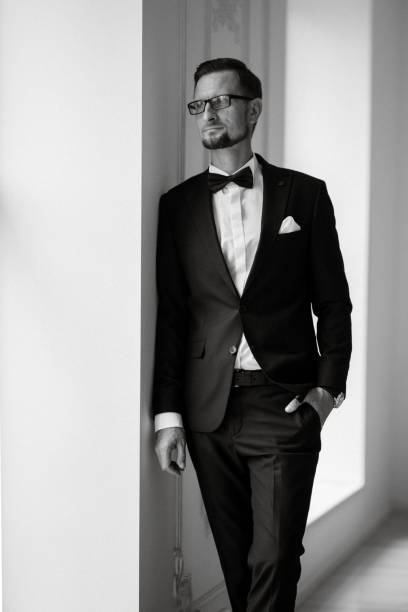 istock groom in a black suit with a bow 1474402108