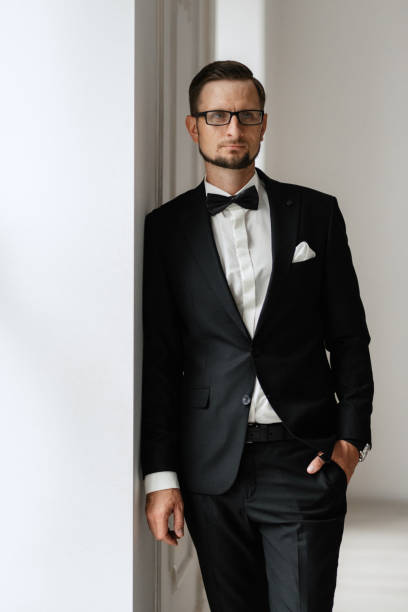 istock groom in a black suit with a bow 1474402223