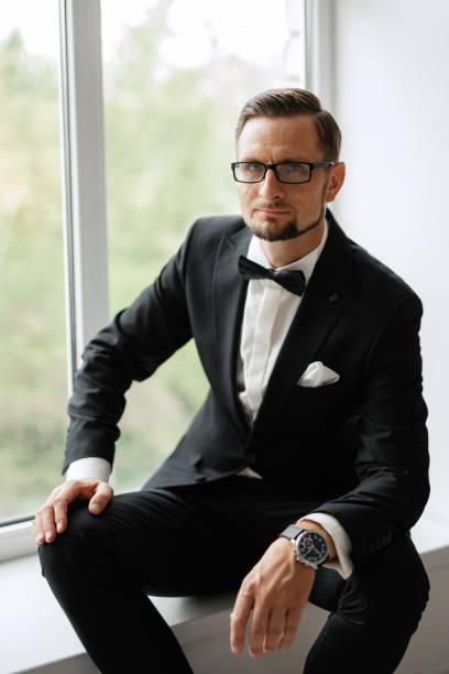 istock groom in a black suit with a bow 1474402305