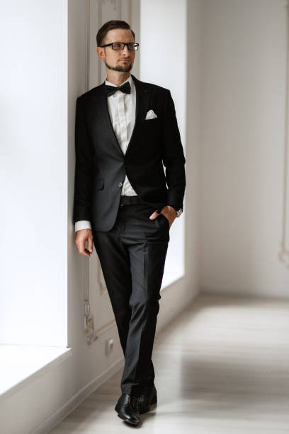 istock groom in a black suit with a bow 1474402799