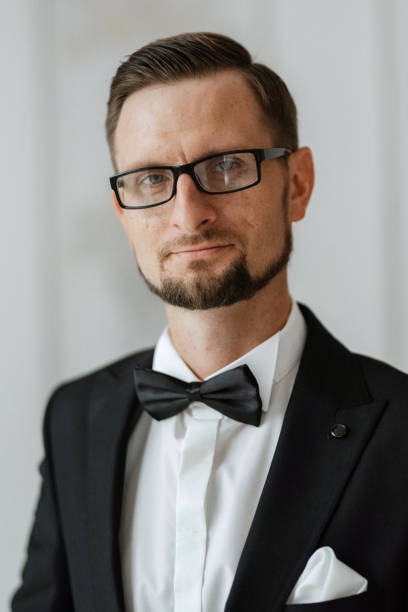 istock groom in a black suit with a bow 1474402812