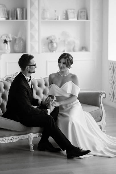 istock groom in a black suit tie and the bride in a bright studio 1474403925