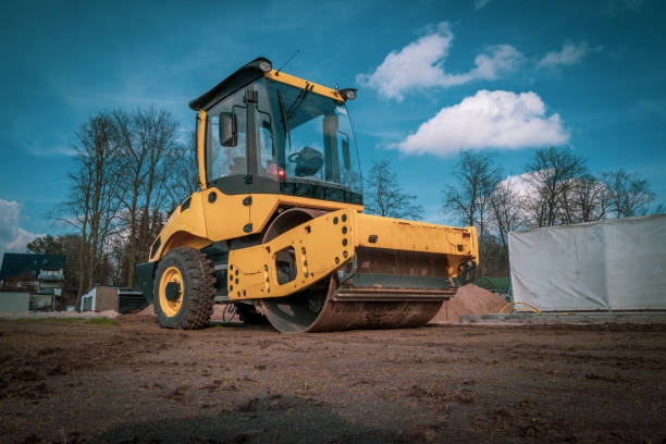 a big bulldozer stands on a sports field