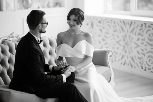 istock groom in a black suit tie and the bride in a bright studio 1474405273