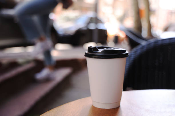 istock Coffee paper cup on wood table in coffee shop 1474405852