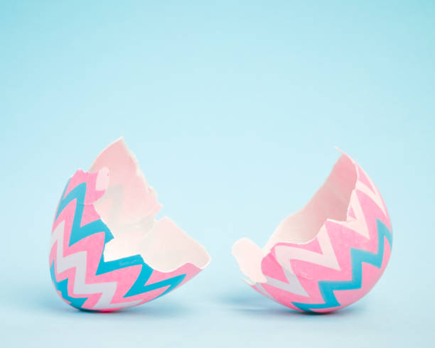 Pink and blue Easter egg open and cracked in half. Empty copy space for text or product.