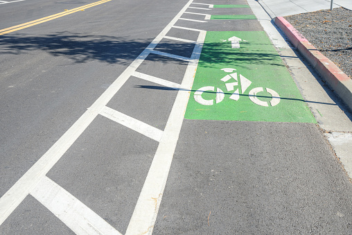 Empty bicycle lane along a road in a business park on a sunny day. Mountain View, CA, USA.