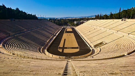 Panathenaic Stadium, Athens, Greece - March 29, 2018: interior of the symmetrical arena of Panathenaic Stadium, the reconstructed ancient stadium under sunlight and clear blue sky