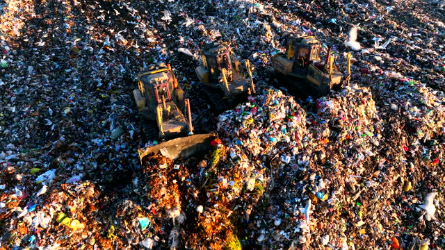 Garbage dump with waste plastic, rubbish and polyethylene. Solid waste disposal and landfill.