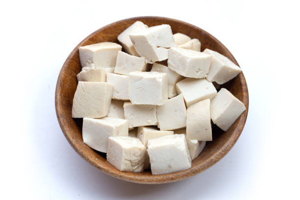 istock White tofu in wooden bowl on white background. 1474412801