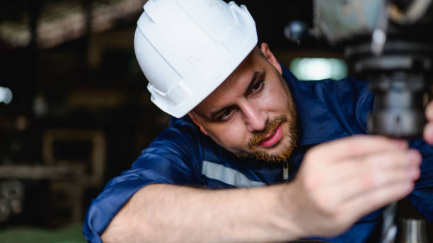 istock Professional male technician checking and repairing machinery 1474414883
