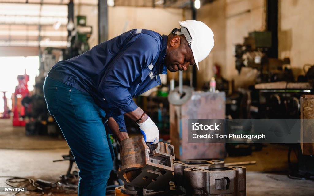 Professional male technician engineer checking and repairing machine Professional male technician engineer checking and repairing machine at manufacturing factory Automobile Industry Stock Photo