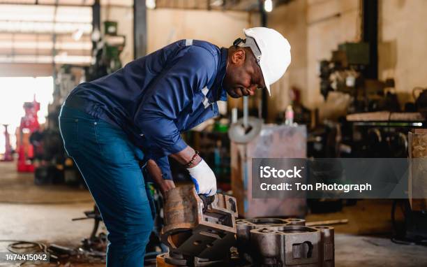 Professional Male Technician Engineer Checking And Repairing Machine Stock Photo - Download Image Now