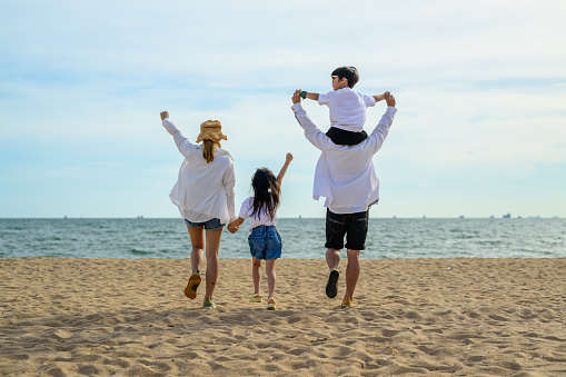 Happy Asian family travel together on beach on holiday, Family with beach travel, People enjoying with holiday vacation, Tropical beach vacation