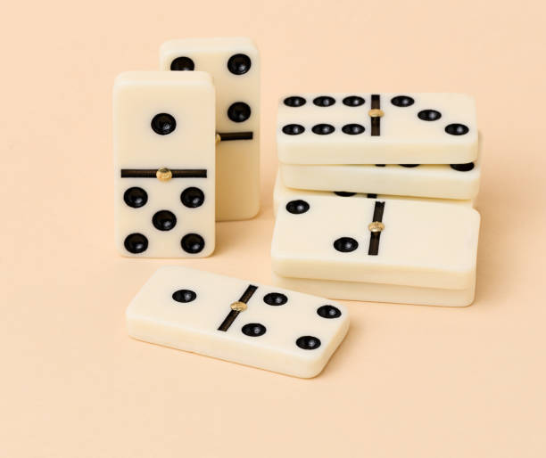 istock A stack of dominoes on a beige background, an intellectual game 1474418585