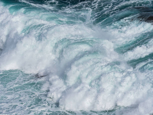istock High angle view of waves breaking on rocks 1474418858