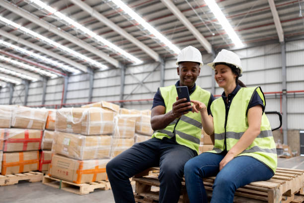 istock Warehouse workers watching videos on social media while on their break 1474426011