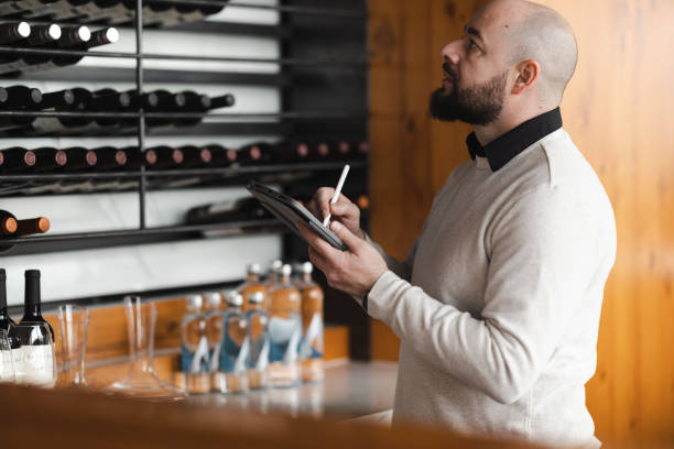 istock Winery Worker by the Wine Rack with a Tablet 1474426754