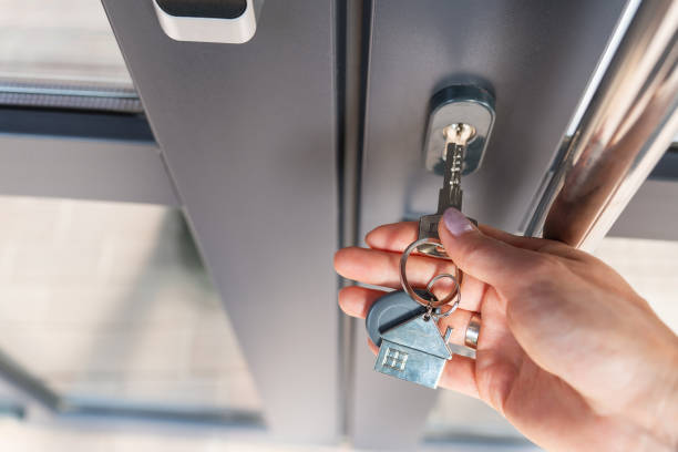 istock A woman's hand opens the door with a key on which the keychain hangs at home. 1474437575