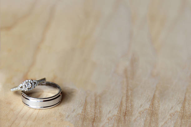 istock Bride and groom engagement rings on a wood table 1474438874