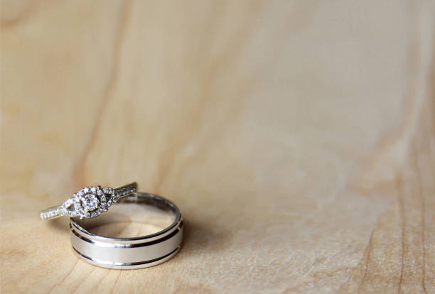 istock Bride and groom engagement rings on a wood table 1474438875