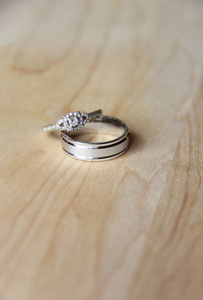 istock Bride and groom engagement rings on a wood table 1474438889