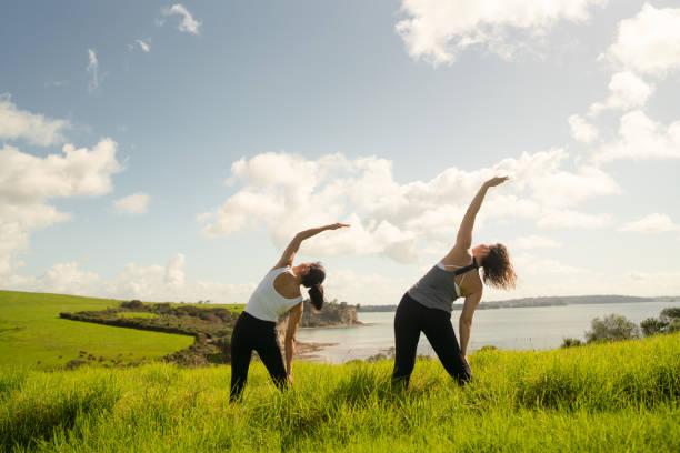 istock Women doing stretching exercise in nature. 1474441124