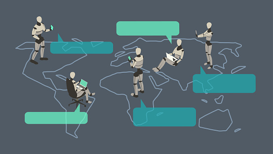 Five robots gather on a stylized world map, communicating via laptops and phones, with speech bubbles or callouts — illustrating the concept of language translation work being performed by artificial intelligence, or machine translation. Illustration uses a unified palette of neutral and turquoise colors, comprised of vector shapes over a dark gray background on a 16x9 artboard, and presented in isometric view.