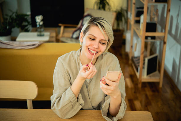 istock Young woman is putting on makeup 1474443249