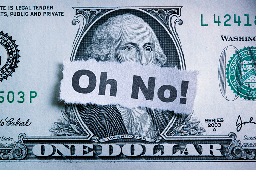Oh No! printed on a torn piece of paper on top of a one dollar bill. George Washington has a surprised look in his eyes.