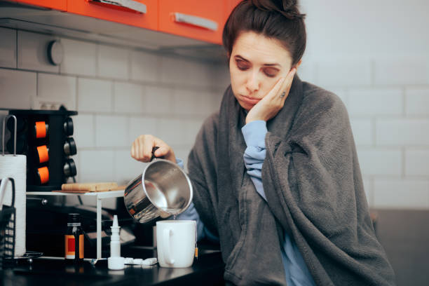 istock Sad Woman Making a Tea Feeling Sick and Cold 1474446397
