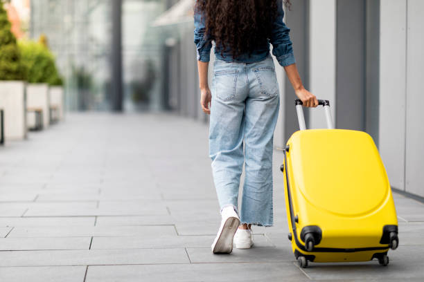istock Unrecognizable young woman having journey abroad, carrying suitcase 1474446996