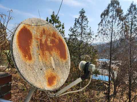 Focus photo of a rusty internet network parabolic antenna