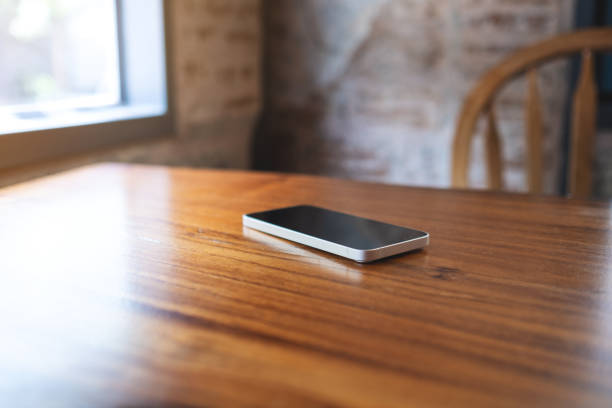 istock A single mobile phone on wooden table 1474463026
