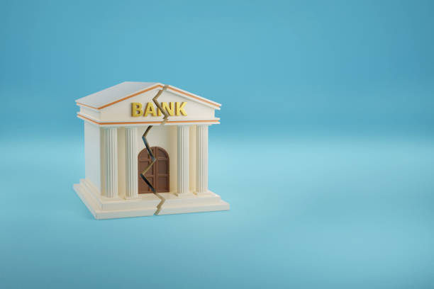 istock Bank building breaking down on blue background with copy space. 3d illustration. 1474467109