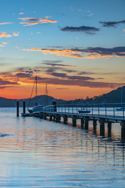 istock Sunrise waterscape with boats and clouds 1474476036