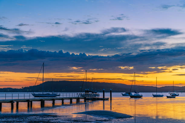 istock Sunrise waterscape with boats and clouds 1474476040