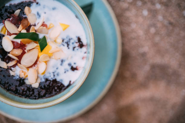 Black sticky rice mixed with fruits and nuts in coconut milk.
