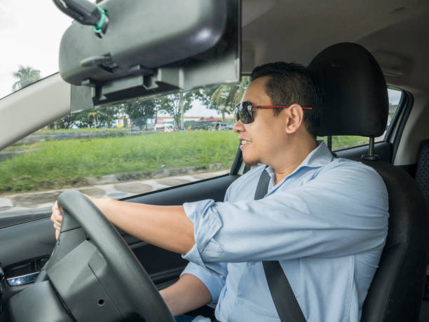istock Young Asian Man Driving a Car 1474478023