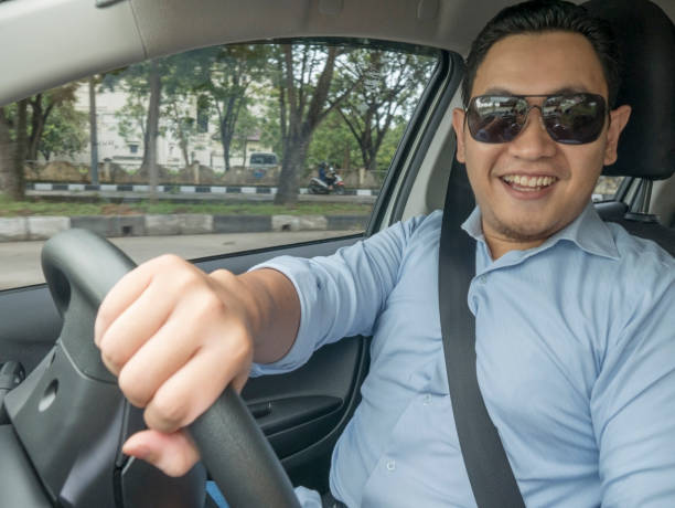 istock Young Asian Man Driving a Car 1474478030