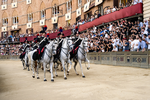 Siena, Italy - August 15 2022: Performance of the Carabinieri a Cavallo Mounted Police at the Prova Trial Race of the Palio di Siena.