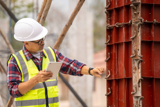 istock An engineer examines a model of a column under construction and uses a laptop to record it. in the construction site 1474482788