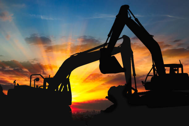 istock Two Black silhouette of excavator loader. 1474484441