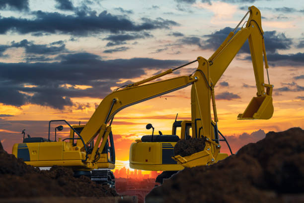istock Two Excavators are digging the soil in the construction site . 1474484443